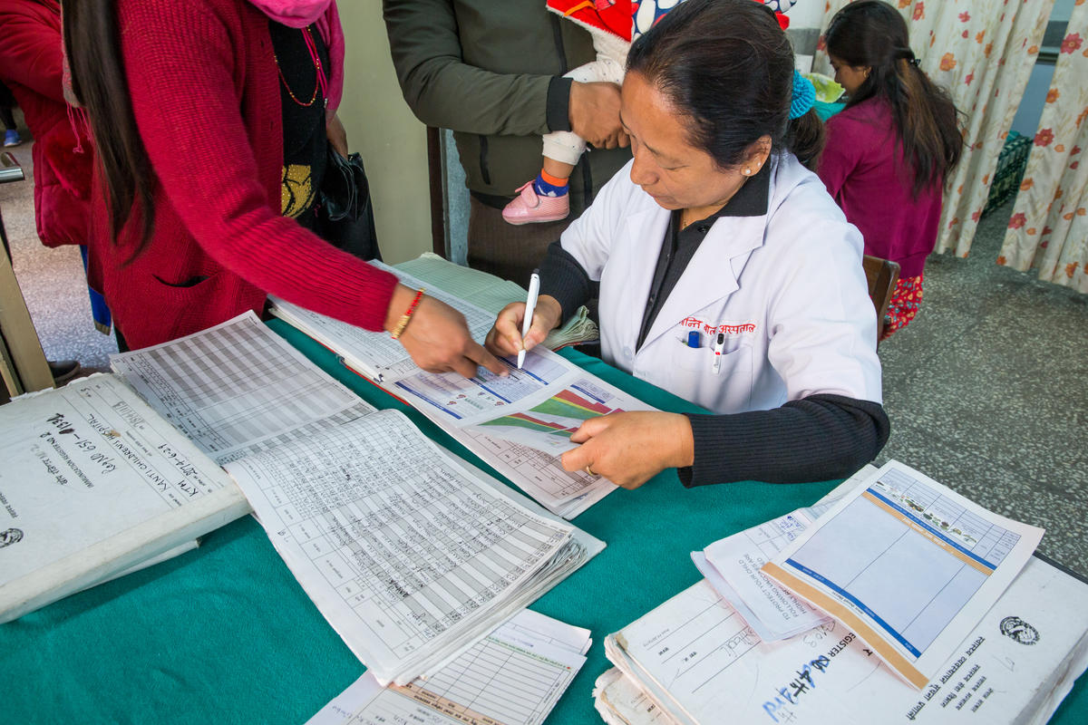 A nurse checks immunization records at the Immunization Clinic at Kanti Children’s Hospital in Kathmandu.