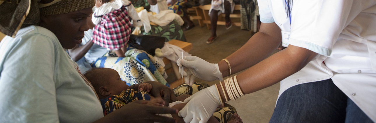 A mother brings her infant son for vaccinations at a public health center in Kabuga, Rwanda.