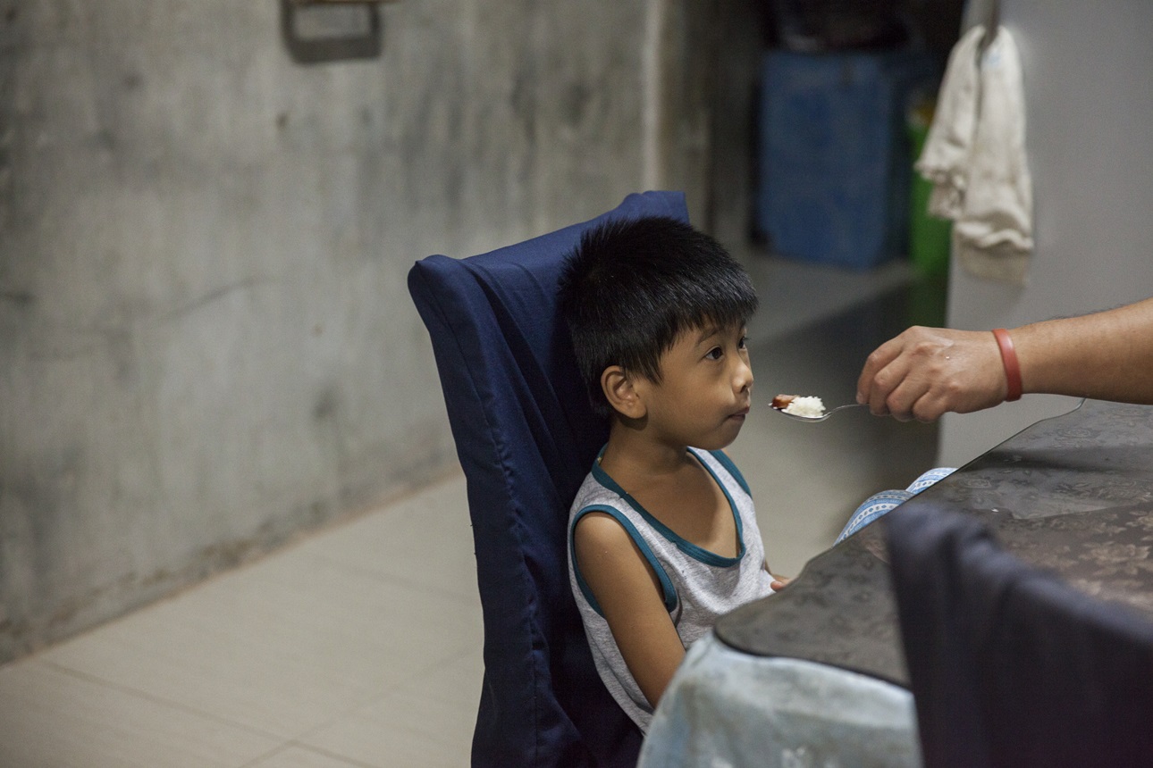 A child eats breakfast at home in Barangay Puypuy, Laguna, Philippines