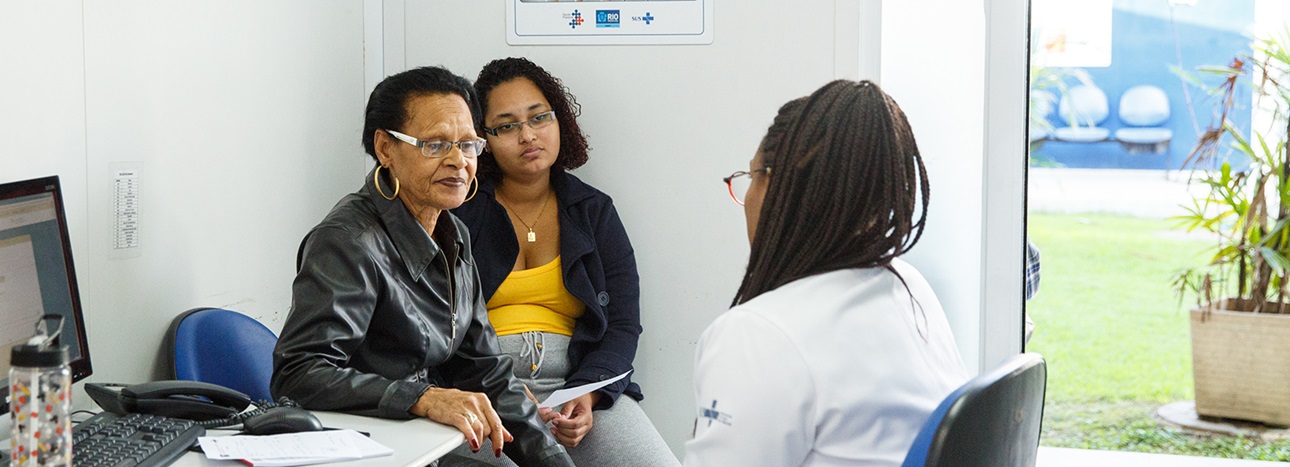 A patient and a relative speak with her doctor at a family health clinic in Rio de Janeiro, Brazil.