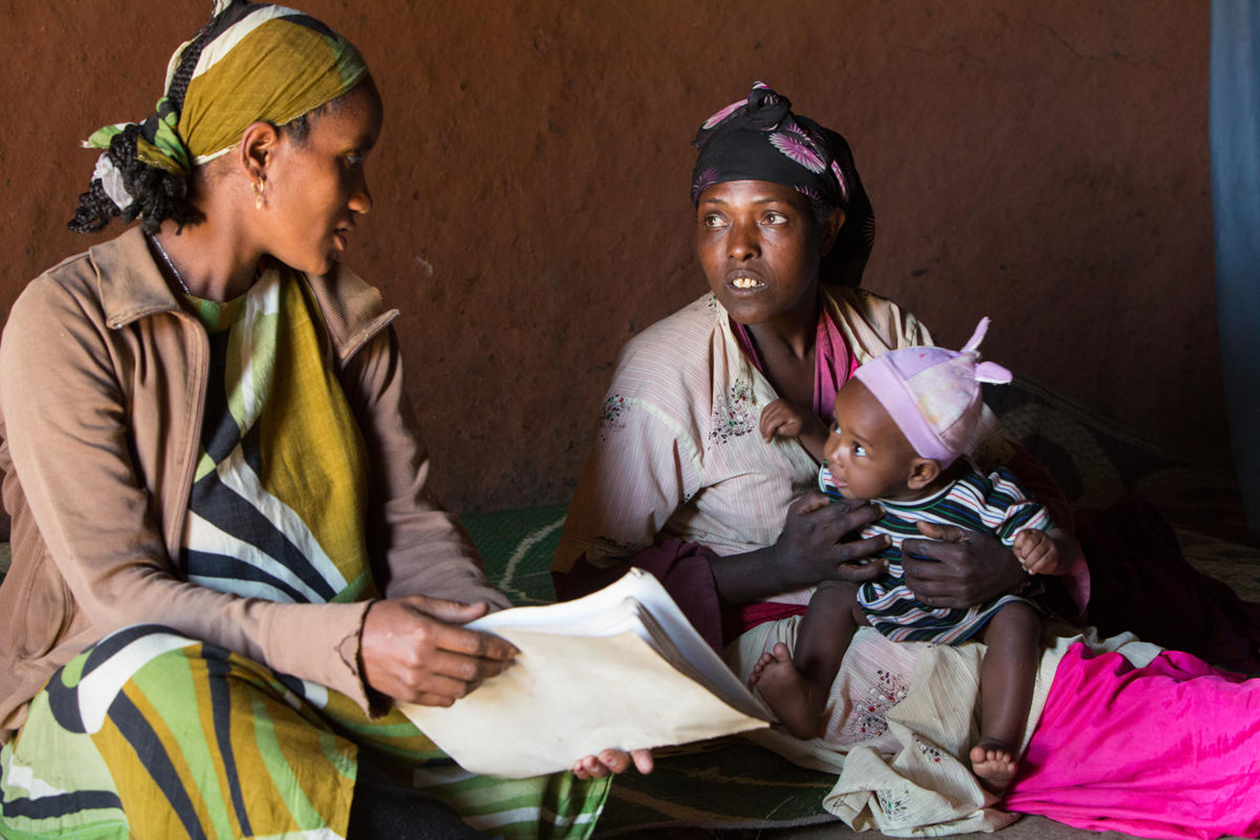 A Health Extension Worker visits a mother and baby in their home in Ethiopia.