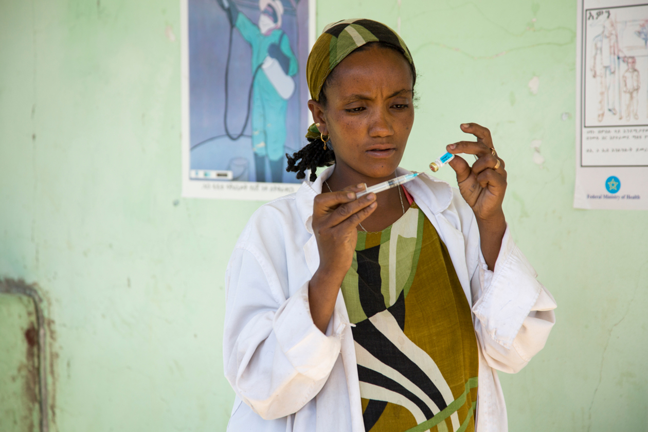 An Ethiopian Health Extension Worker prepares vaccinations for infants. 