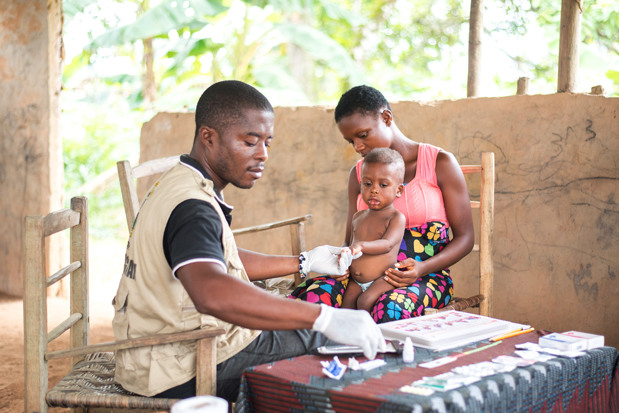 A community health worker administers a rapid diagnostic test for malaria in Rivercess County, Liberia.