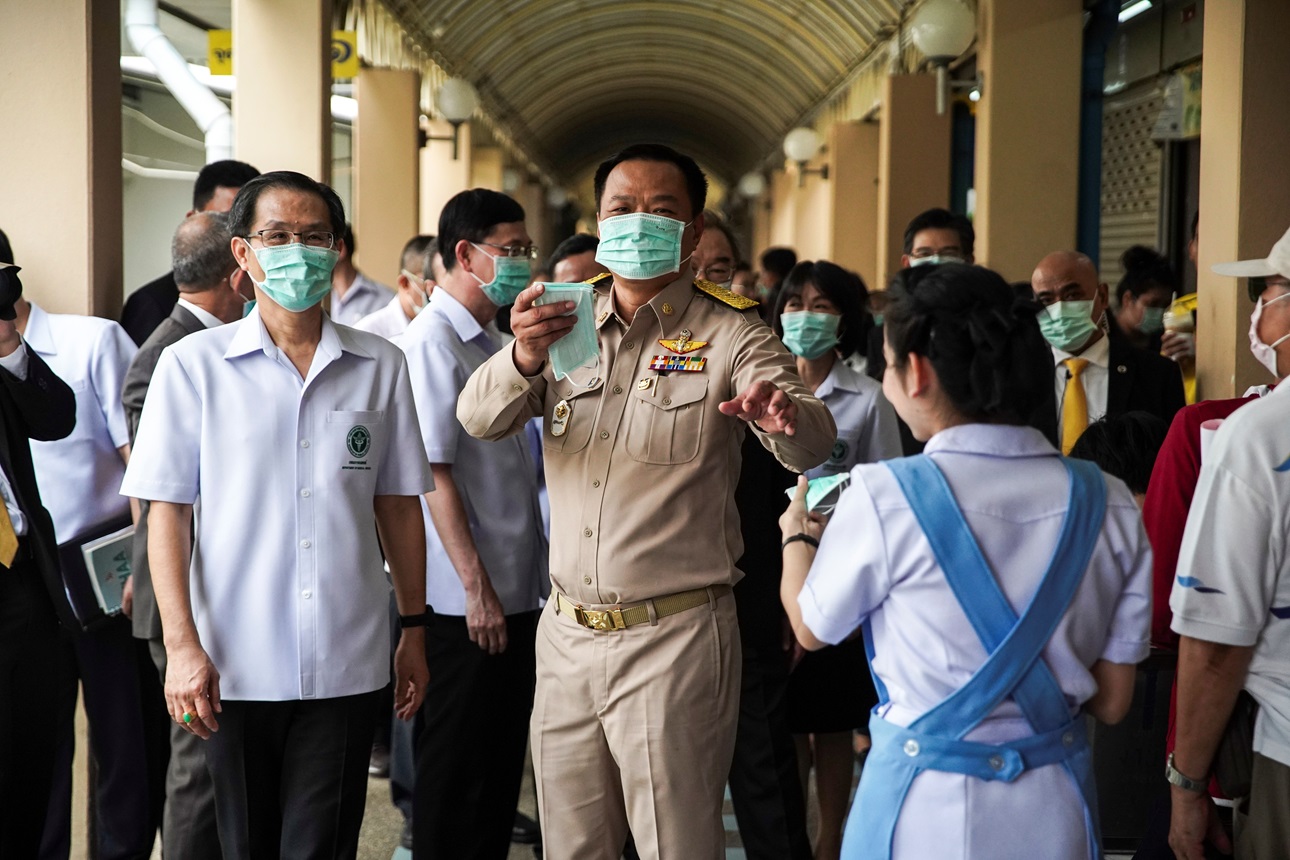 Anutin Charnvirakul, Thailand's Deputy Prime Minister and Minister of Public Health distributes protective face masks to people at a hospital before a news conference about the new coronavirus situation in Bangkok, Thailand, February 3, 2020.