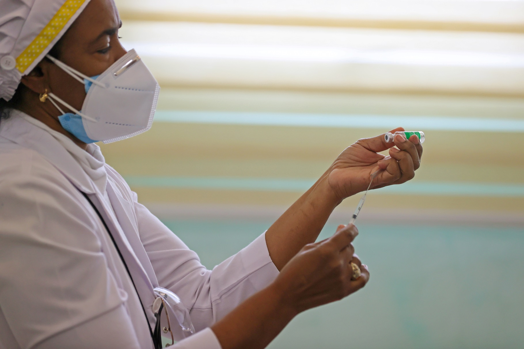 A healthcare worker prepares to administer a dose of the Oxford/AstraZeneca vaccine against COVID-19, in Santiago, Dominican Republic, February 17, 2021. 