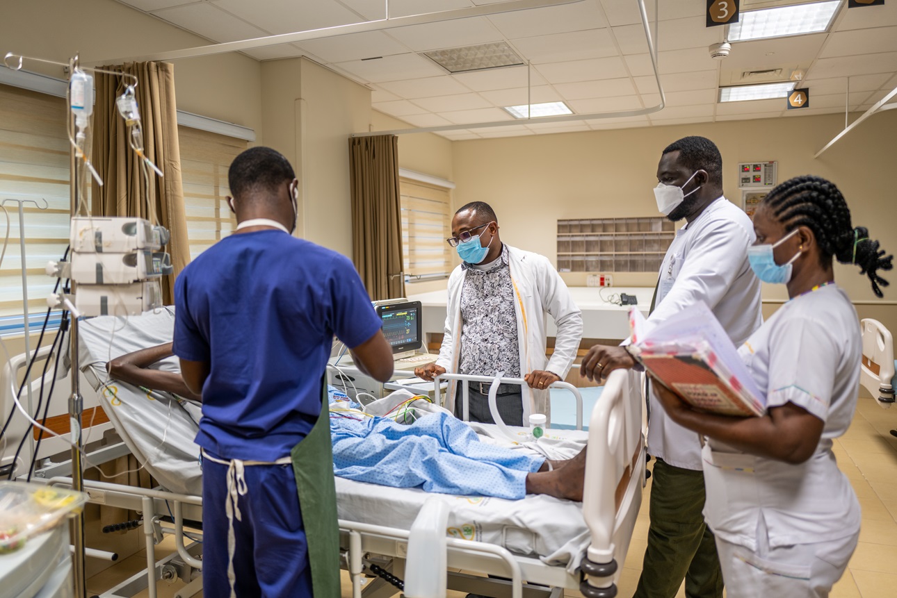 Nurse Daniel Mireku Akomeah dresses a patients wounds as Doctors, Evans Akomea and Peter Kwamina McCarthy look on at the University of Ghana Medical Center in Accra, Ghana, on June 24, 2022. Credit: Nana Kofi Acquah. 