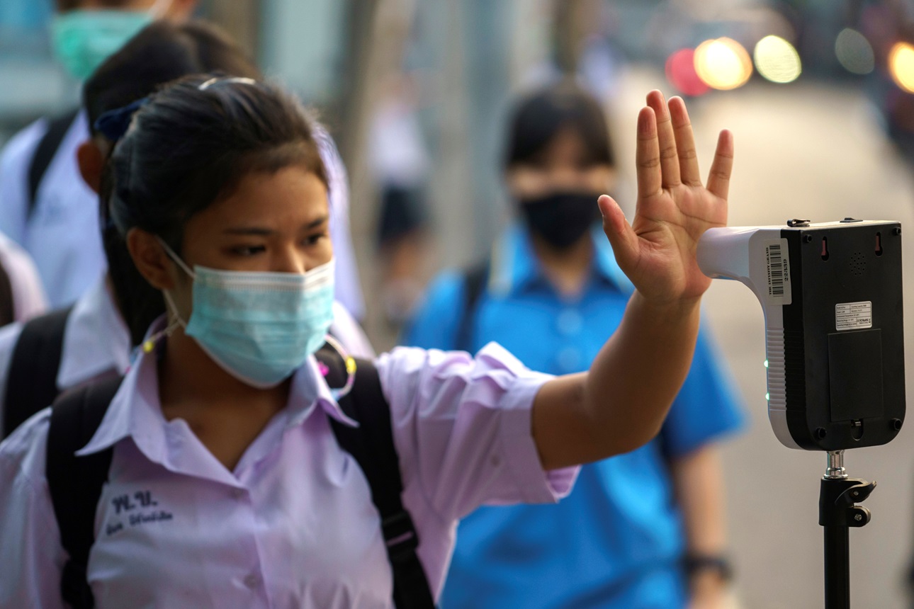 A student wearing a face mask undergoes a temperature check to prevent the spread of the coronavirus disease (COVID-19), as schools nationwide reopened in Bangkok, Thailand, February 1. 2021. 
