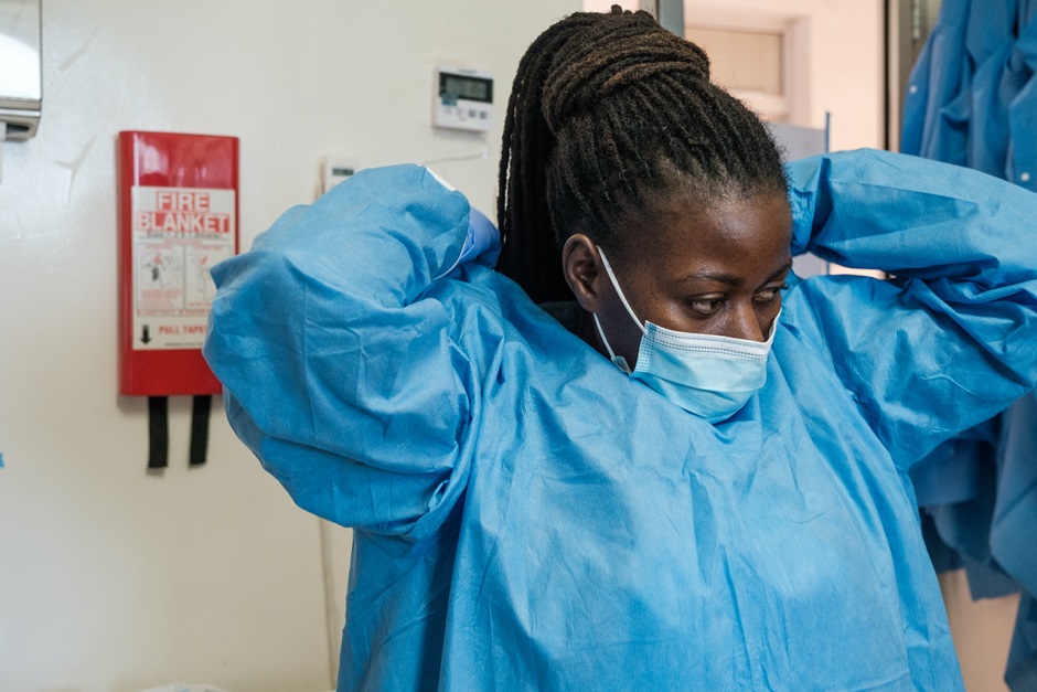 Lab worker Jackie Nkamoga dresses for work at the Uganda Virus Research Institute (UVRI) in Entebbe, Uganda, on January 21, 2022. 