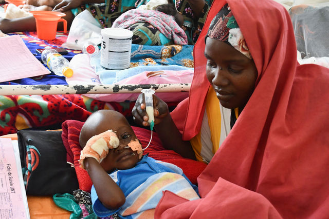 A woman feeds her malnourished child in Chad.