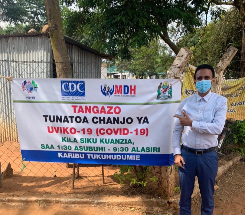 A U.S. CDC Tanzania team member with a vaccine schedule.