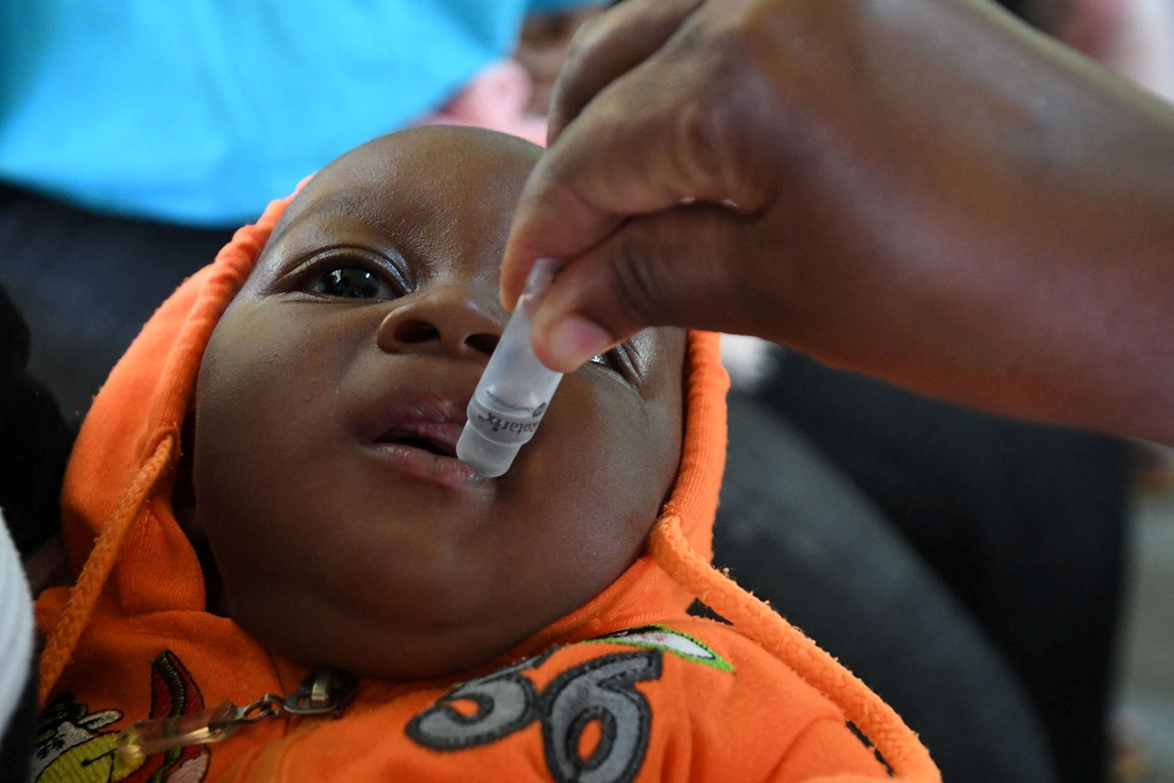 A baby receives the Rotavirus vaccine in Uganda, which used experience from previous campaigns to improve COVID vaccinations.