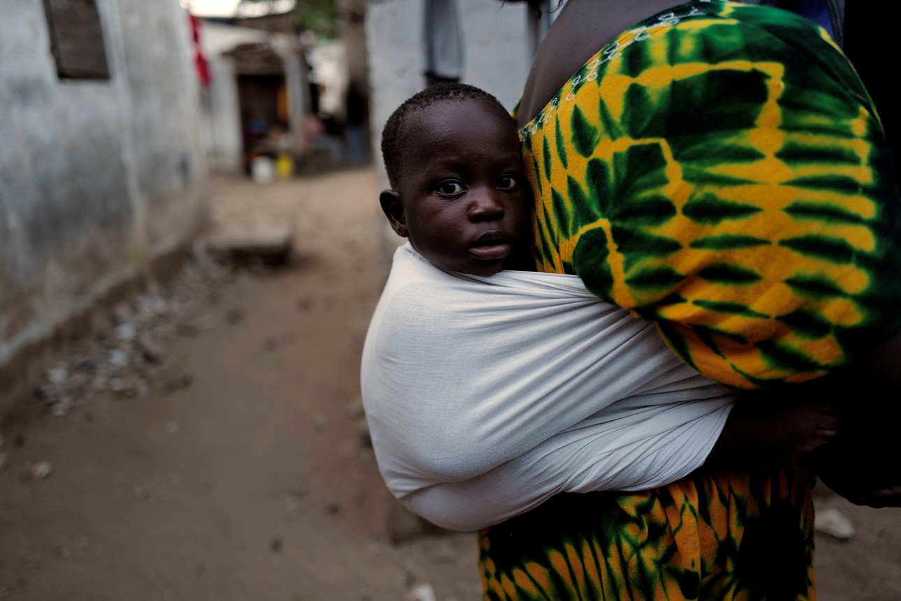 A mother carries her baby boy in Dakar, Senegal.