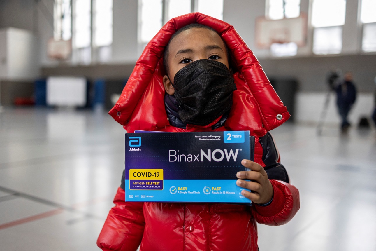 A child holds a rapid at-home COVID-19 testing kit in Philadelphia, Pennsylvania, U.S. 