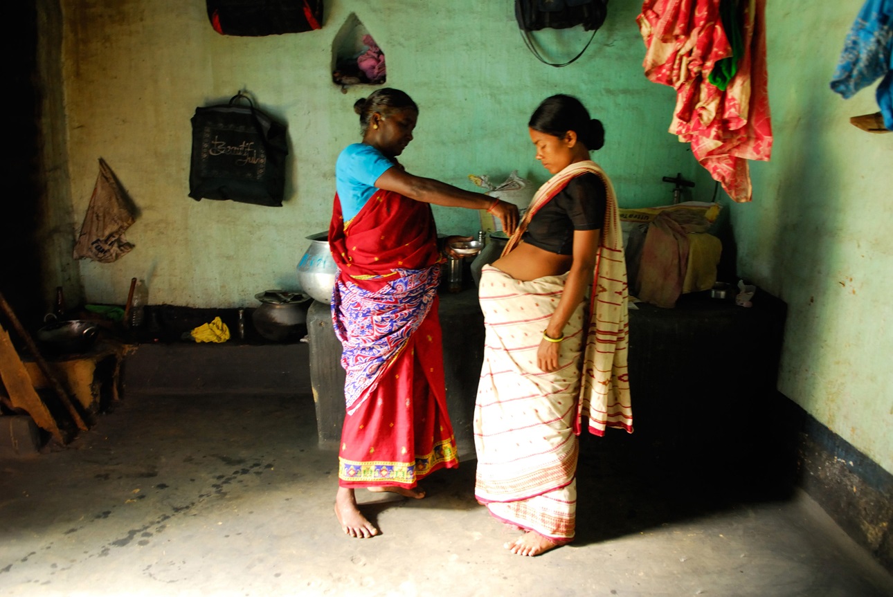 A midwife tends to a pregnant woman in India.