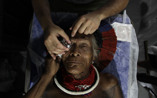 A man from Brazil's Kayapo tribe receives medical care in the Amazonian rainforest.