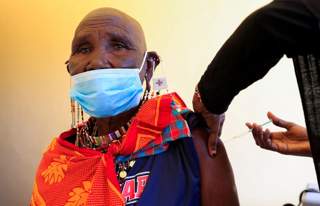 A Kenyan woman receives her first dose of the coronavirus disease.