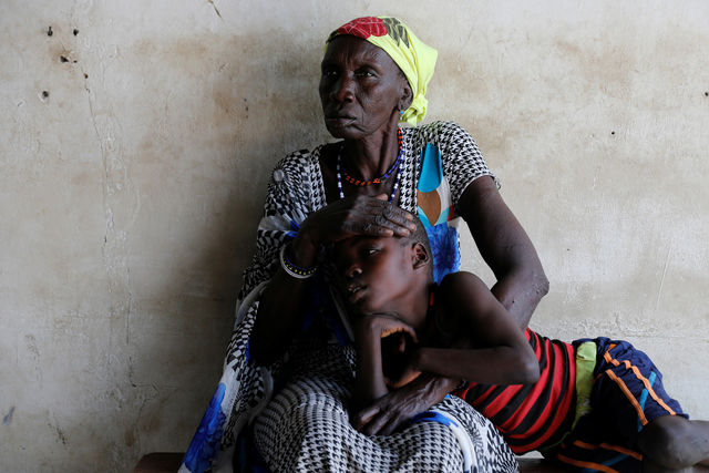A mother comforts her malaria-afflicted son in South Sudan.