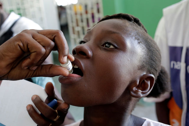 A girl receives an oral cholera vaccine in Haiti.