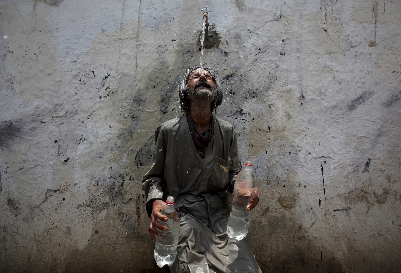 A man cools off during an intense heat wave that killed hundreds in Karachi in 2015.