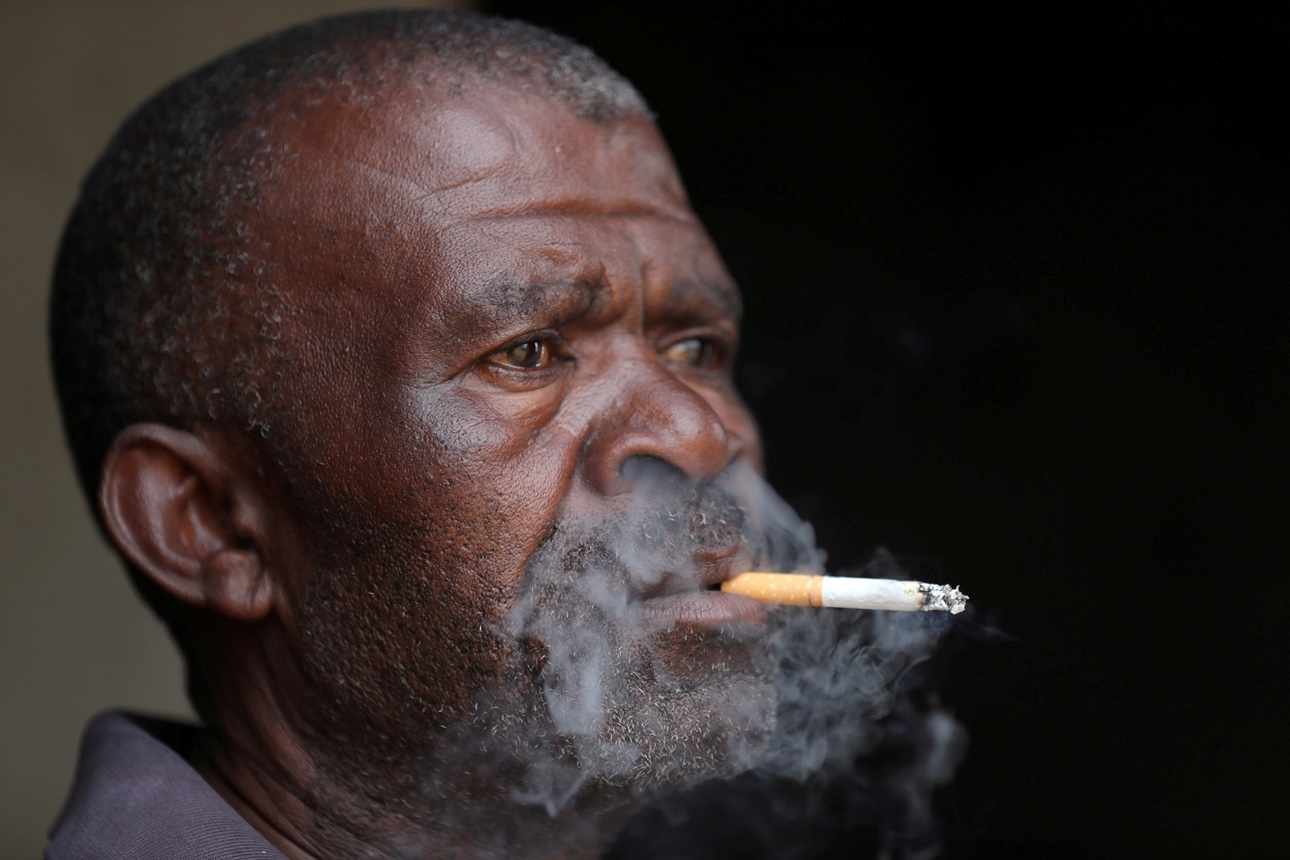 A man smokes a cigarette in South Africa.