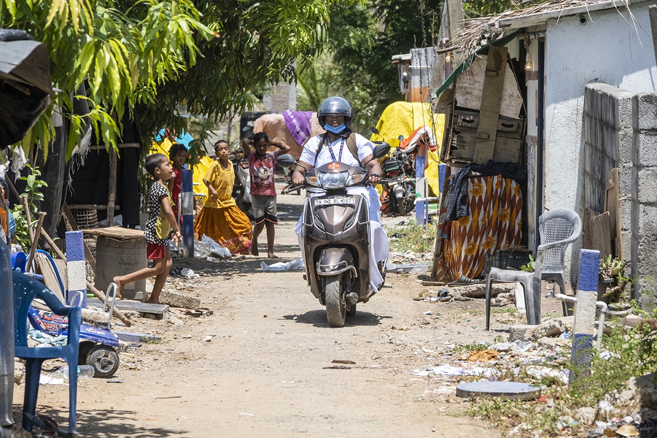 A village health nurse rides her scooter to conduct outreach visits in rural areas of Tamil Nadu.