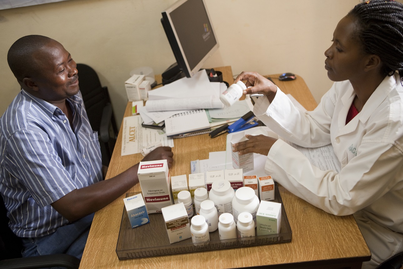 Nutritionist Claudette Kayitesi counsels François Iyamuremye (45) as he receives his monthly anti-retroviral medication at TRAC Plus Clinic in Kigali, Rwanda on December 15, 2011.