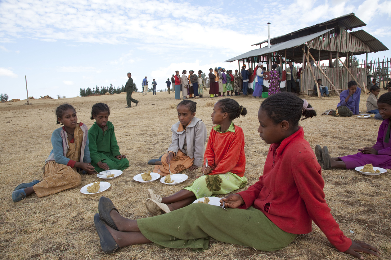 Community members of Debre Tsige village in the Oromia Region gather for a meal. 