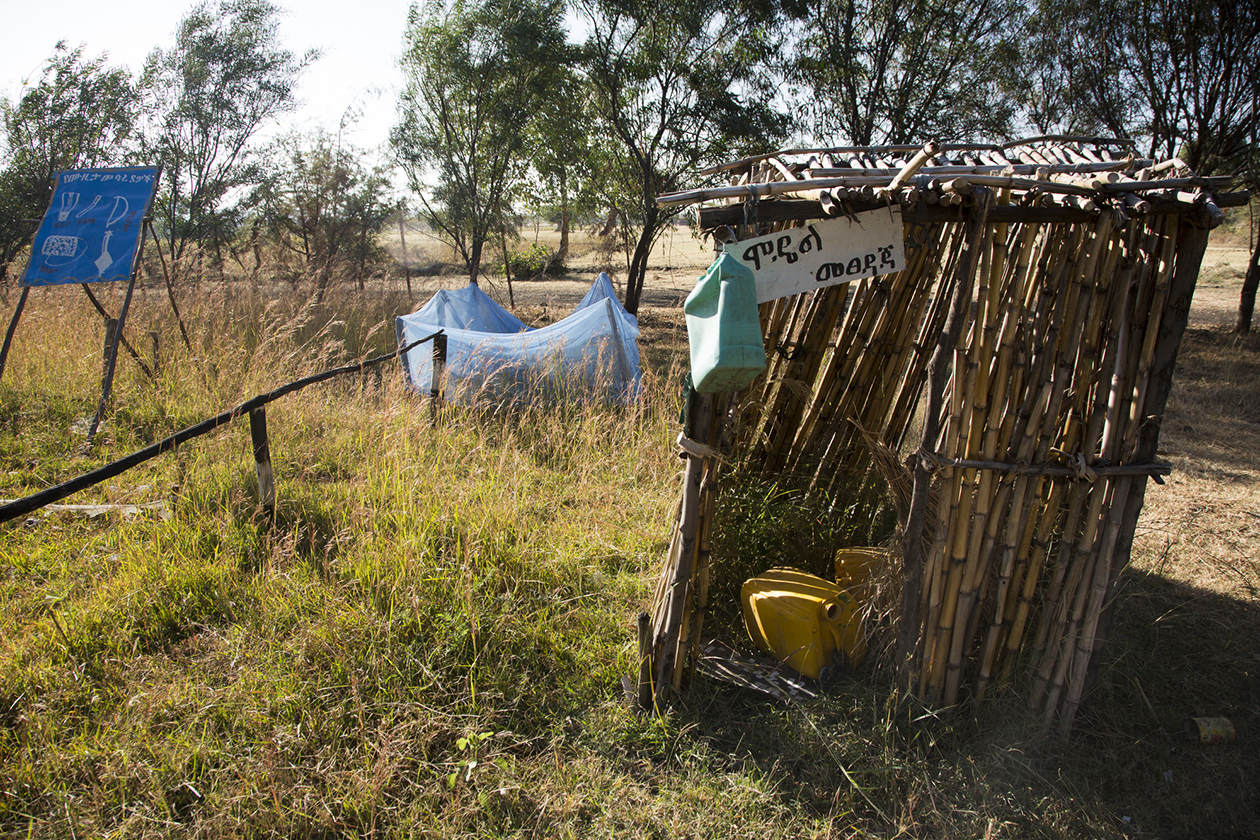 An outhouse stands in the middle of a field at a primary school.