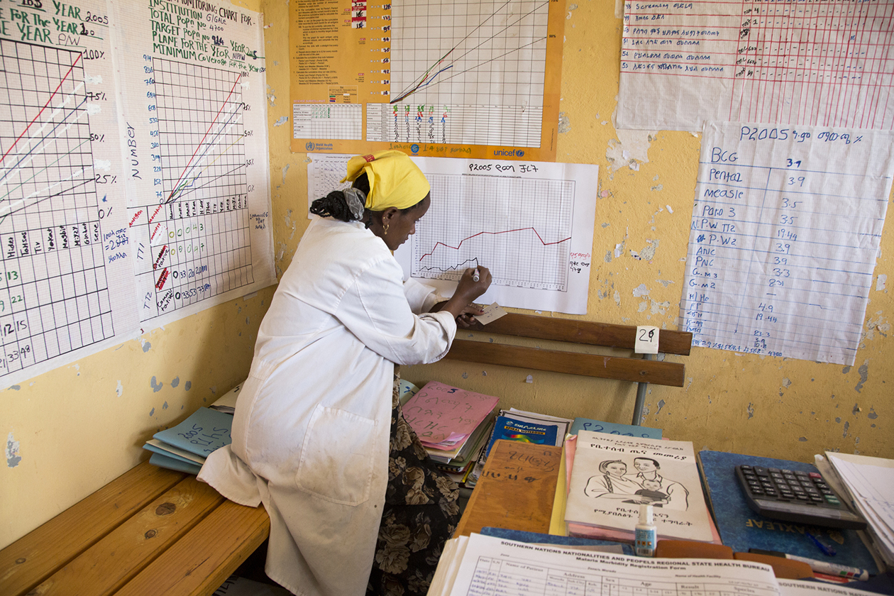 Yetagesu Alemu, a Health Extension Worker at the Germama Gale Health Post filling out disease surveillance charts