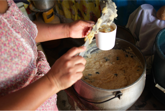A mother in Peru cooks healthy food for her children.