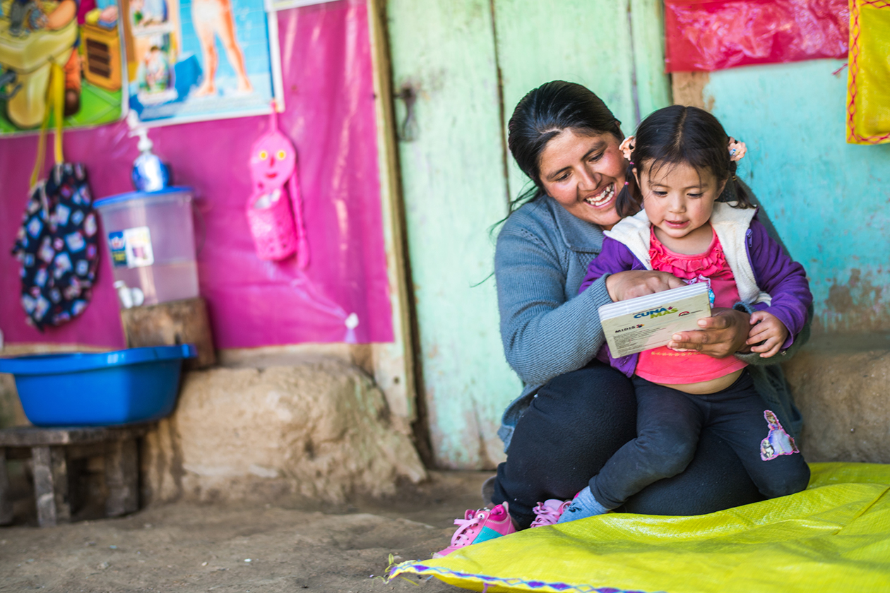 A mother holds her daughter during a visit by health workers in the Chinchao district of Huanuco, Peru.