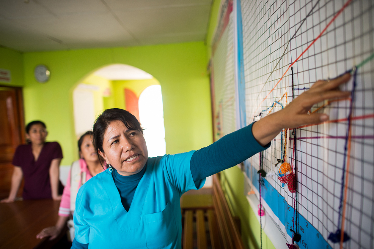 A health care worker in Peru discusses the growth rates of local infants.