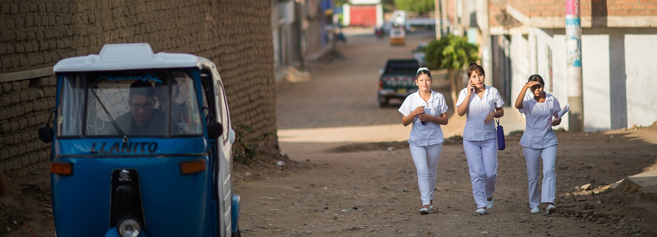 Nurses walk outside a clinic in the Huánuco region of Peru.