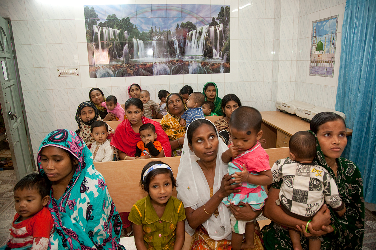 Mothers and their children wait to see healthcare professionals in Mirpur, Bangladesh.