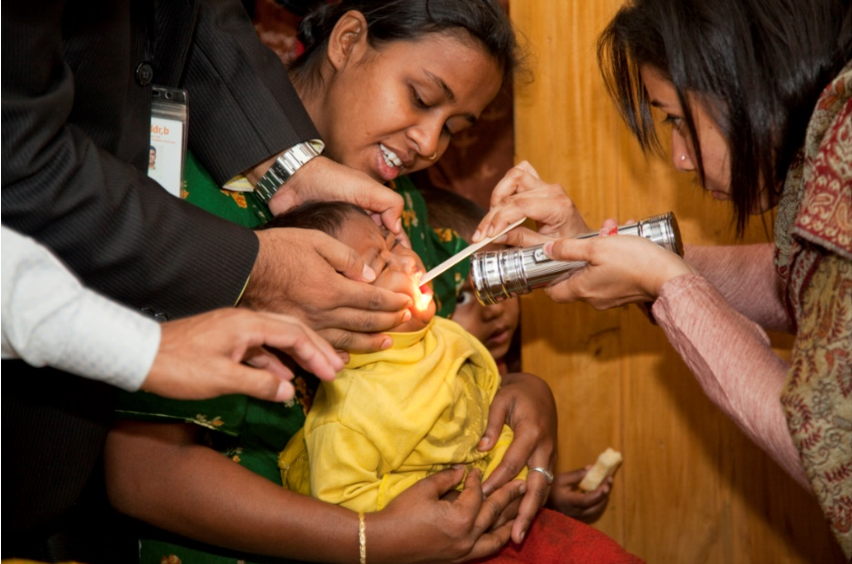 Health workers examine a child at the Kamalapur Urban Surveillance Site Field Office and Clinic in Bangladesh.