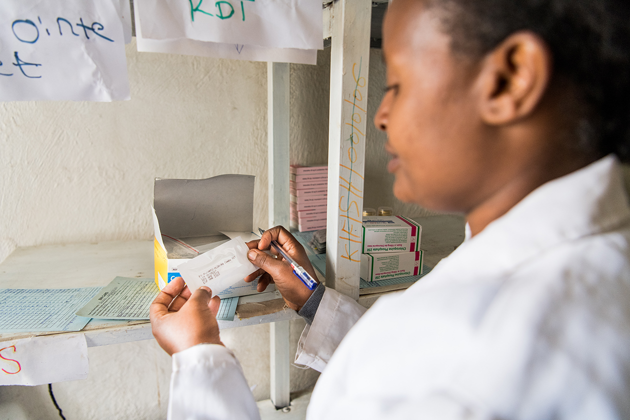 A health extension worker examines medication at the Shera Dibandiba health post center near Mojo town, Ethiopia