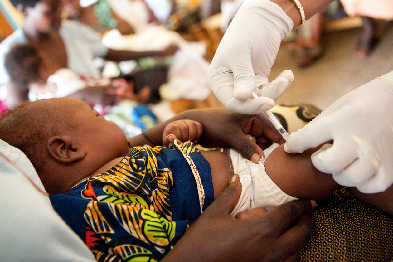 A child receives a vaccination in Rwanda.