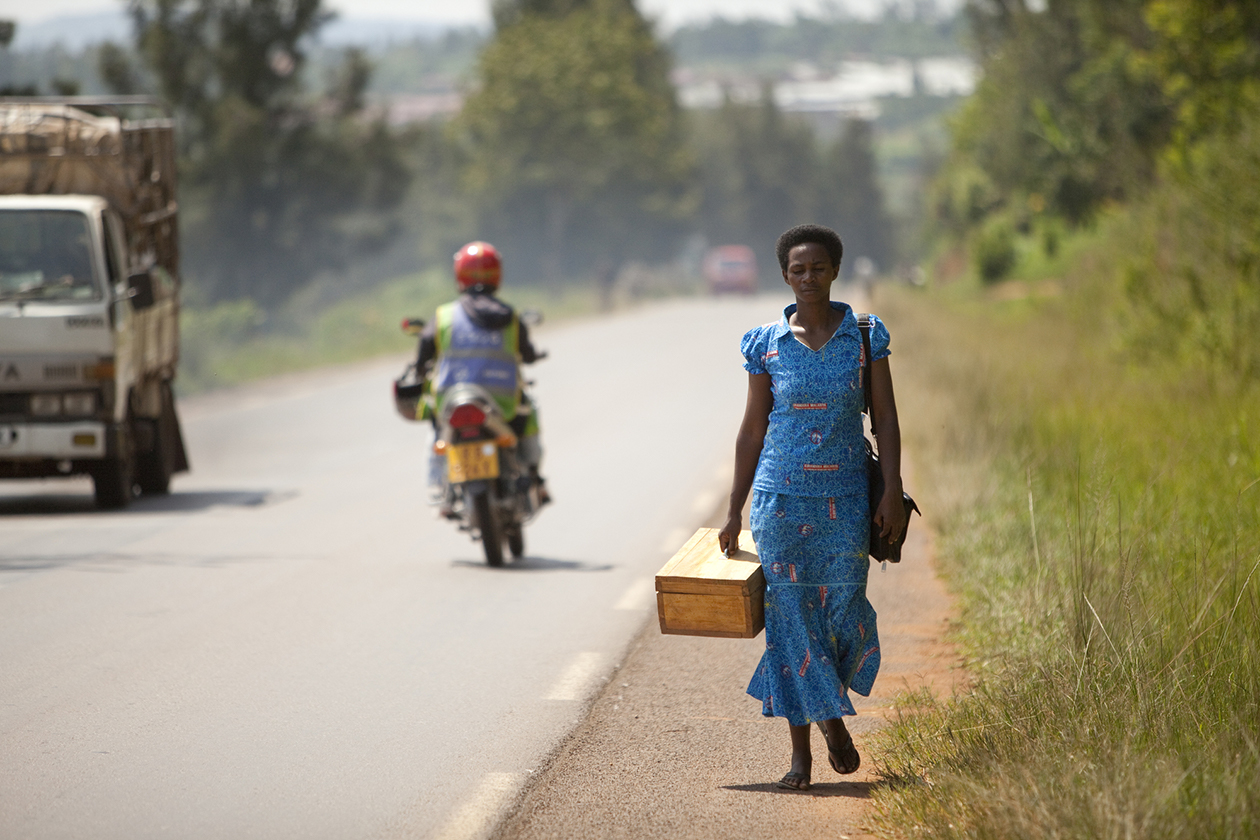 A community health worker walks to make a home visit in Rwanda.