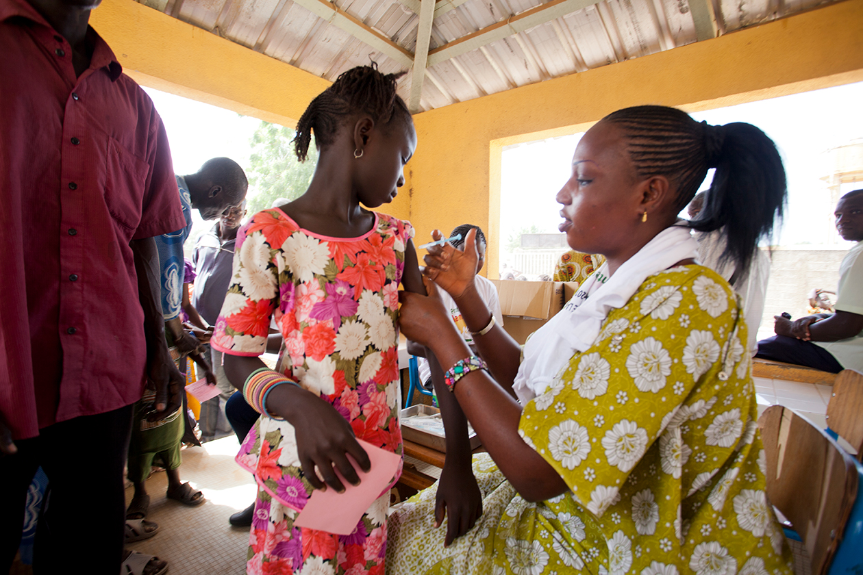A health worker administers a vaccination in Senegal.
