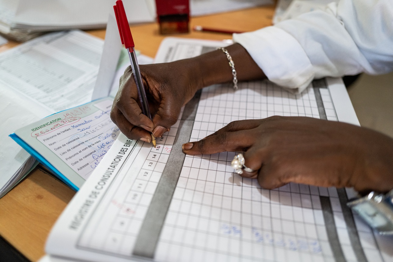 A nurse and staff member fills out patient documents at a Hospital in Dakar, Senegal 